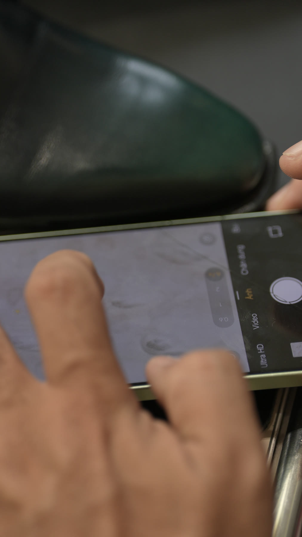 The microscope lens on the Midori toe, the pores visible on the phone screen